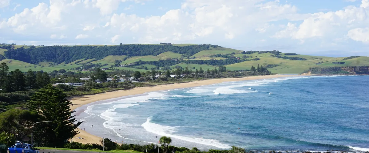 Coastal Australian community beneath green hills